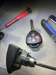 car key and ignition lock cylinder with tools for automotive locksmith repair service