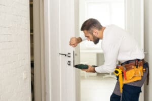 professional locksmith installing door lock using tools for home security service